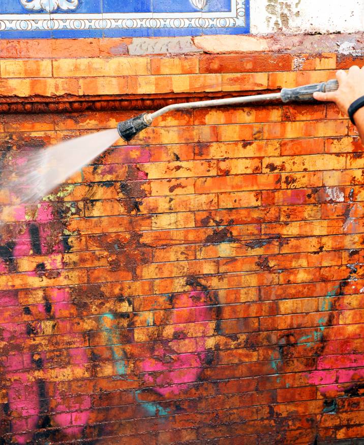 Image of hand Cleaning graffiti with high pressure  jet